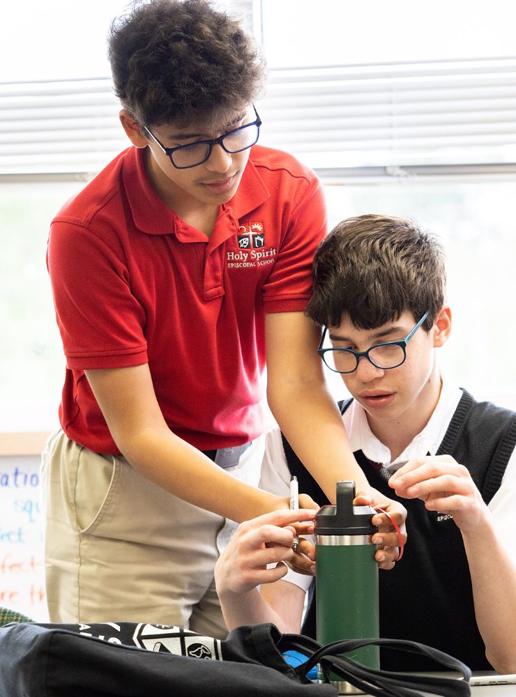 Two middle school students working together in a classroom