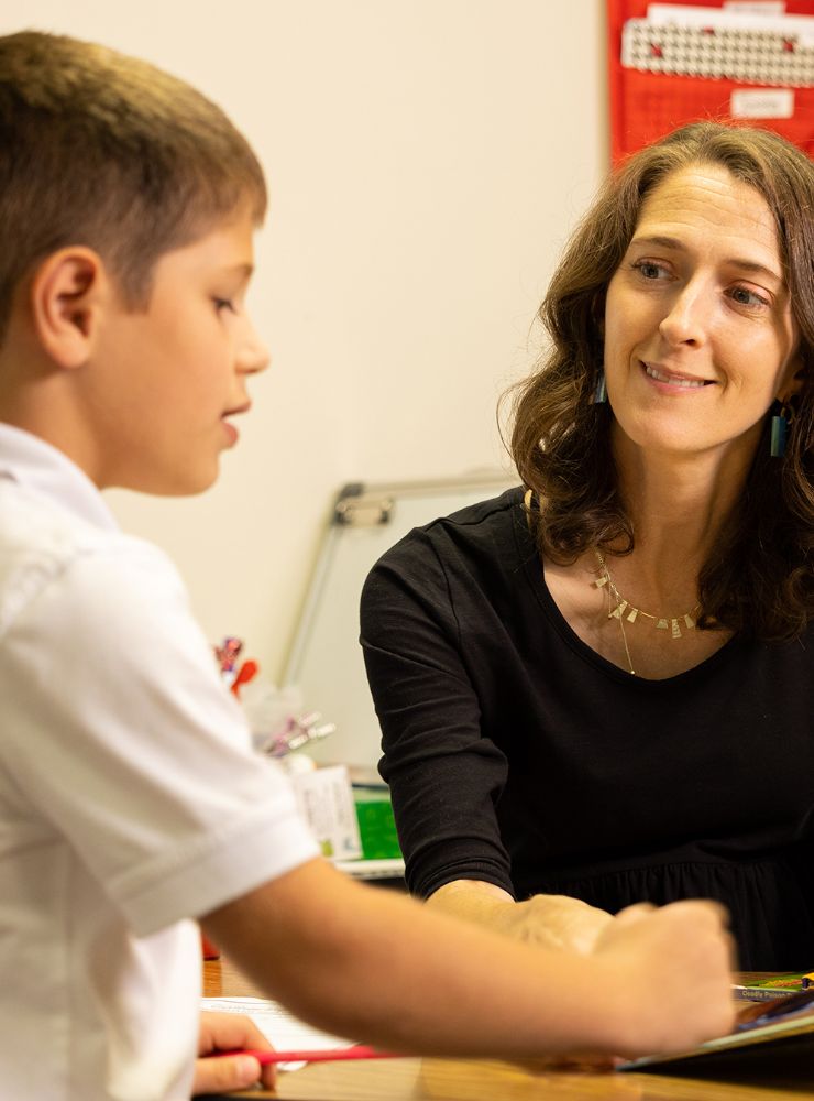 Lower school student and teacher in a classroom